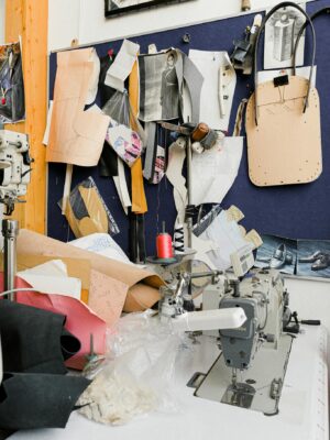 A vibrant sewing studio with a sewing machine, patterns, and threads, showcasing a creative workspace for tailoring and design.