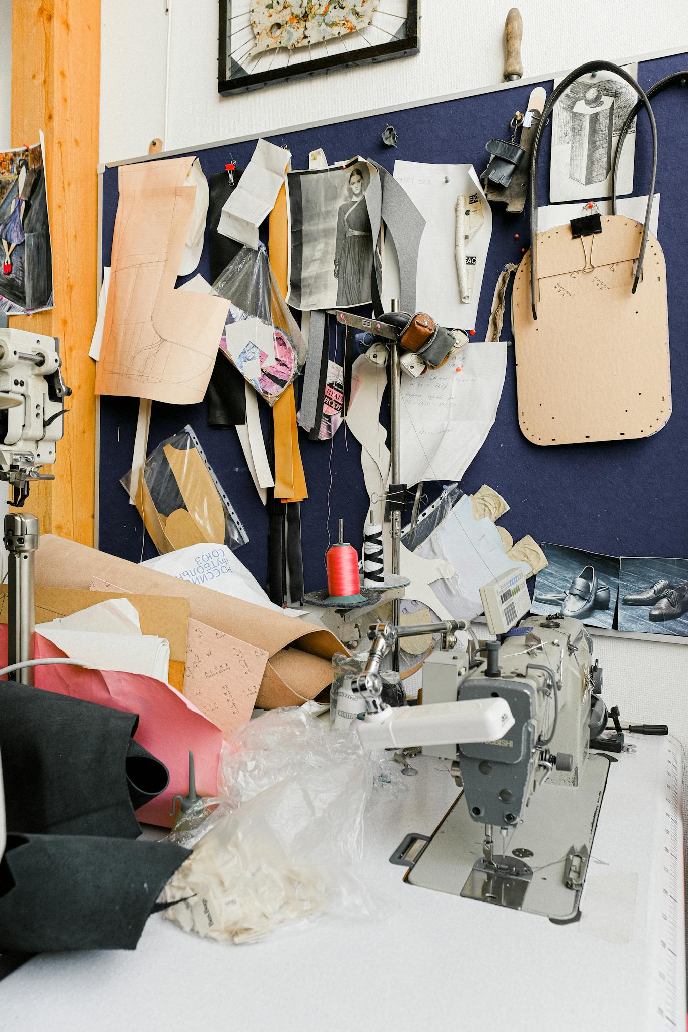 A vibrant sewing studio with a sewing machine, patterns, and threads, showcasing a creative workspace for tailoring and design.