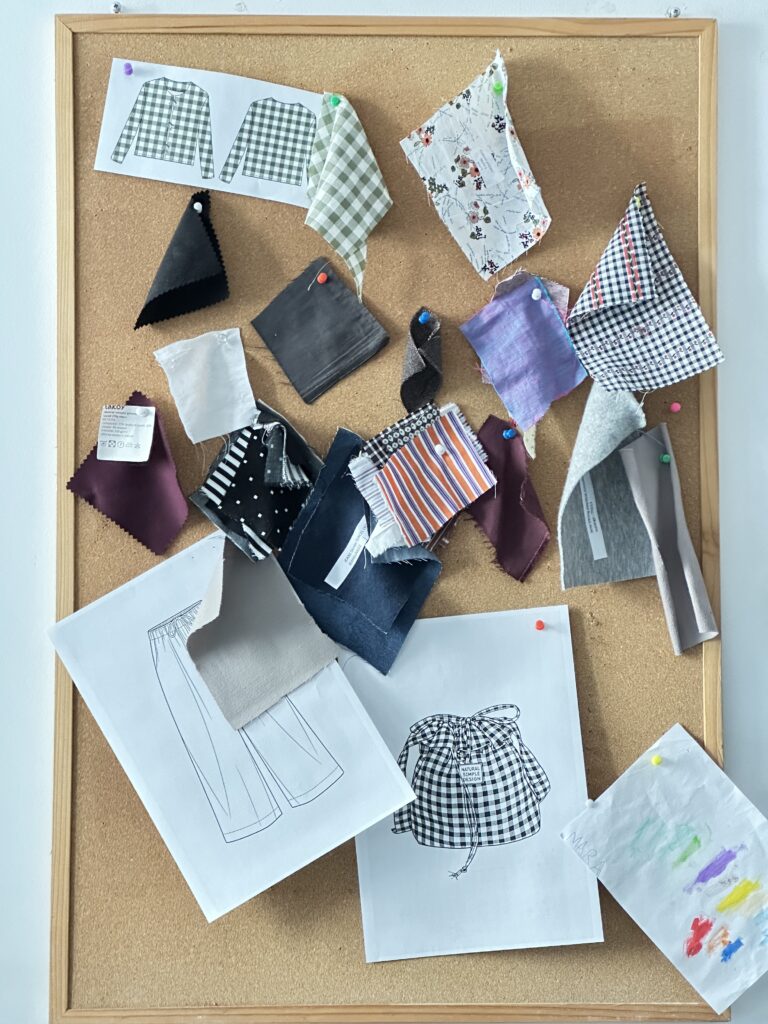 Printed PDF sewing pattern pages laid out with fabric swatches