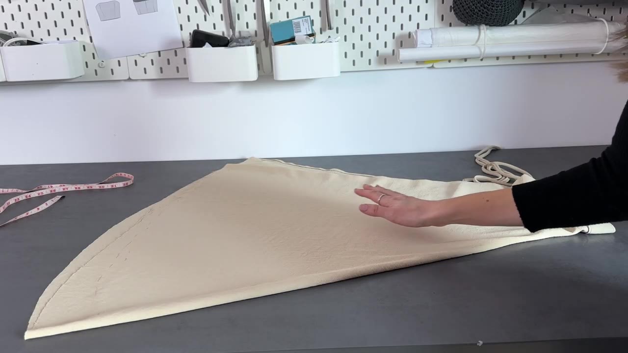 Laying out the skirt fabric flat with a tape measure