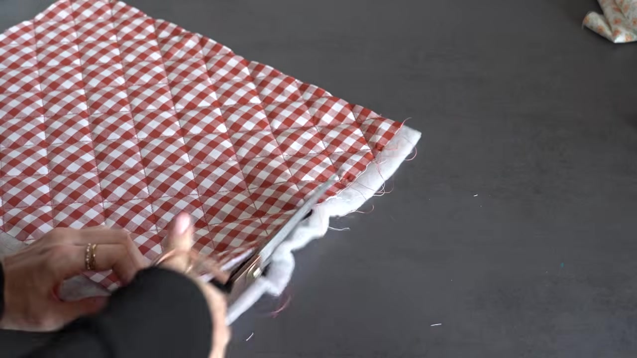 Quilting straight stitch lines across the layered makeup bag fabric