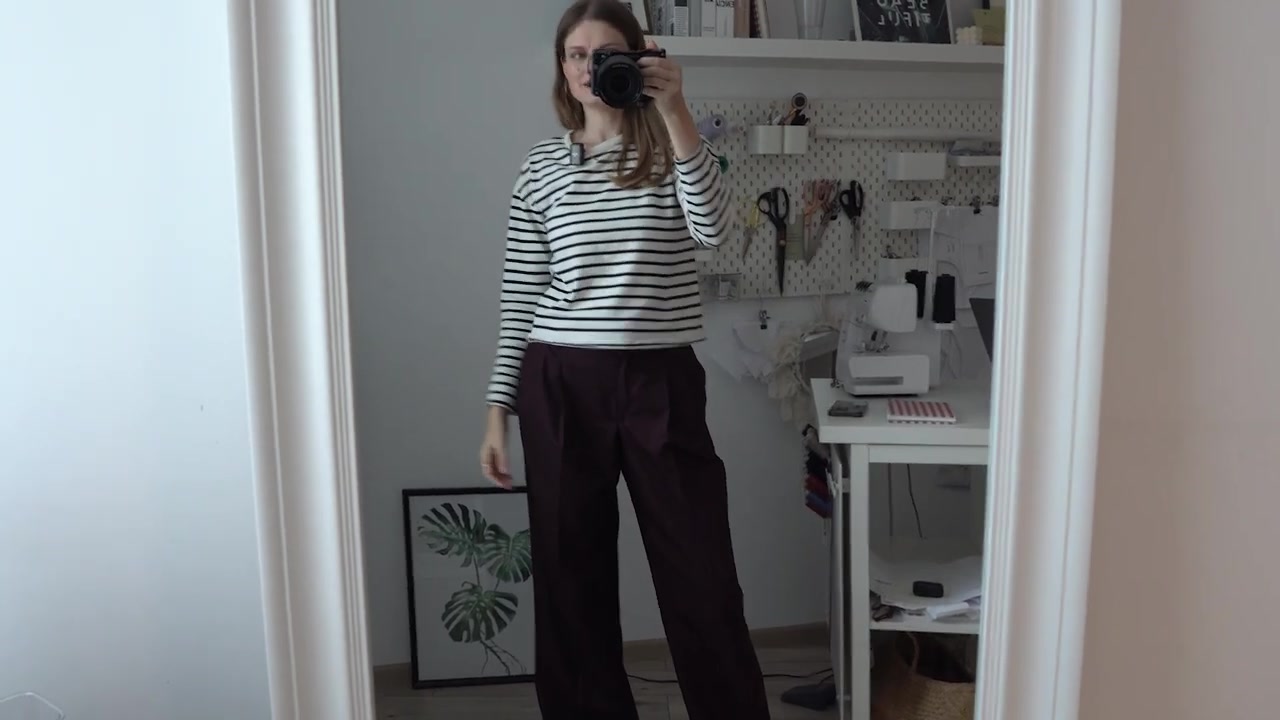 Wide-leg black trousers styled with a striped knit top