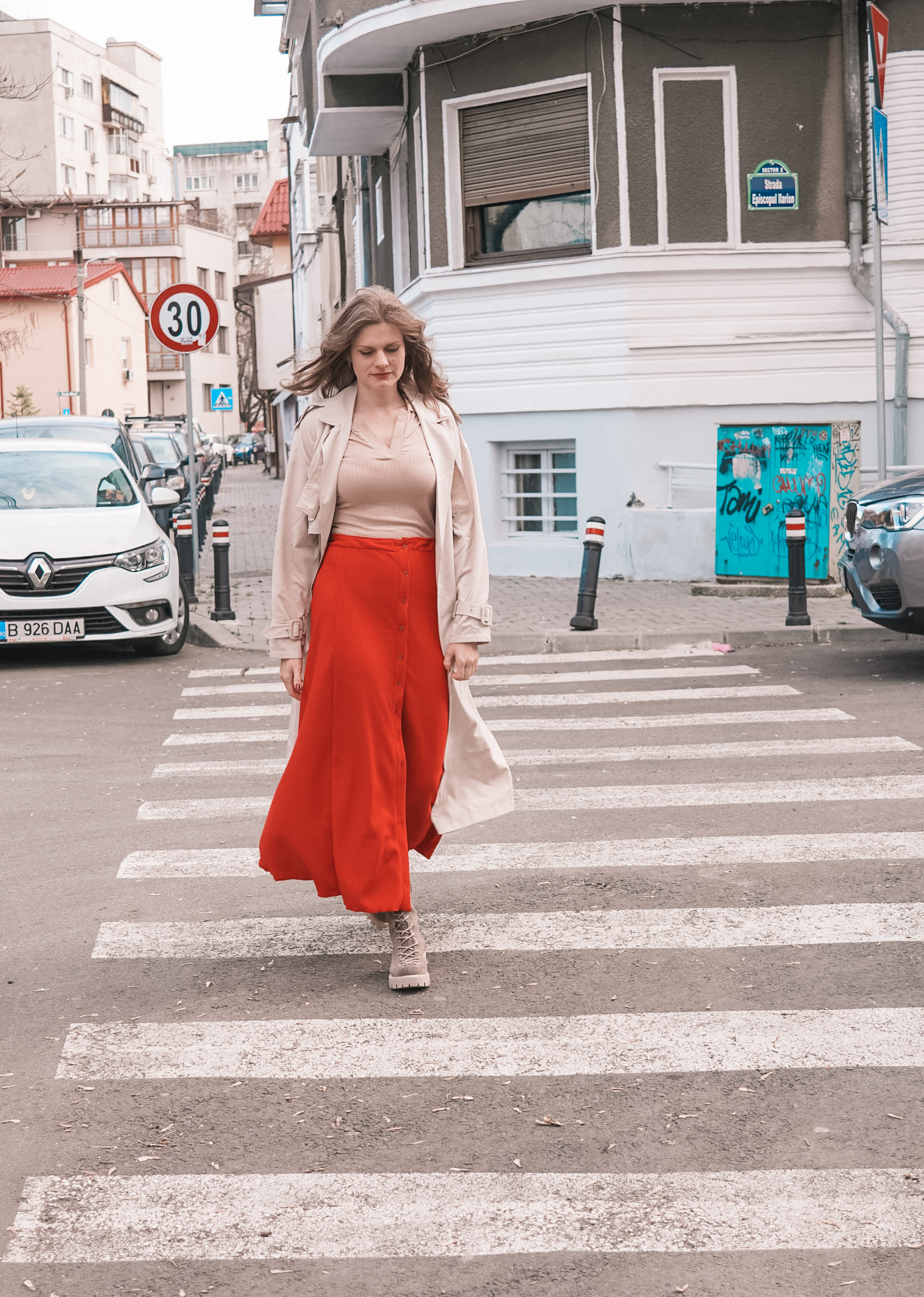 90s A-Line Skirt in red ribbed knit with a button front, worn walking across a city street