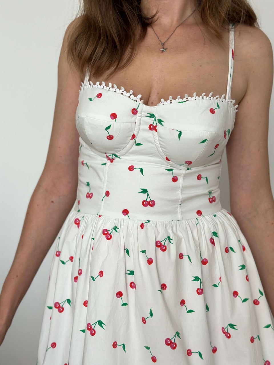 Close-up of the cherry print bustier bodice — seamed bust cups and sweetheart neckline