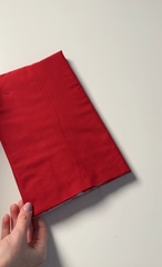 The fabric tube pressed flat with the wadding inside