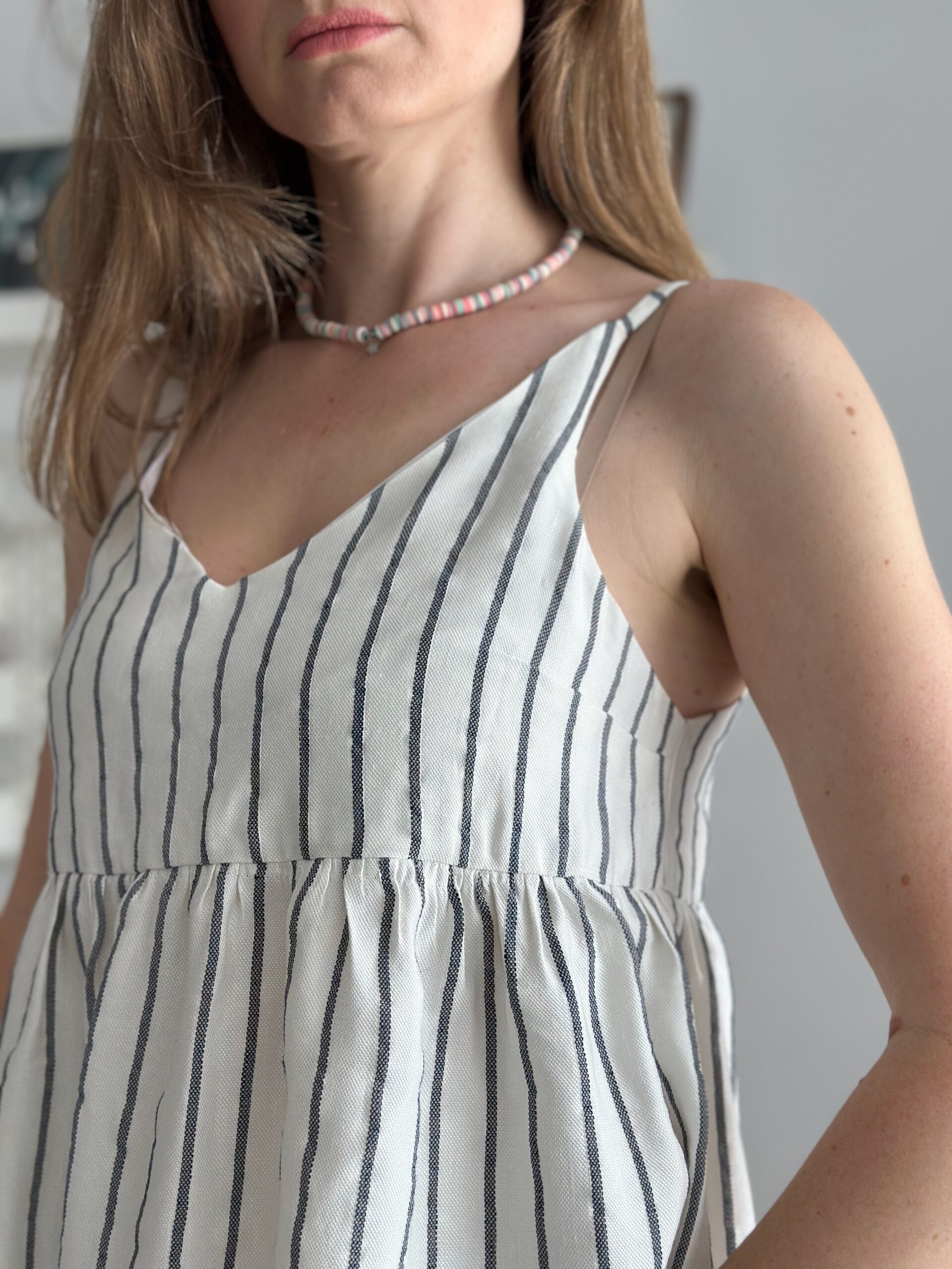 Close-up of the sundress neckline with slim straps and soft V-neck