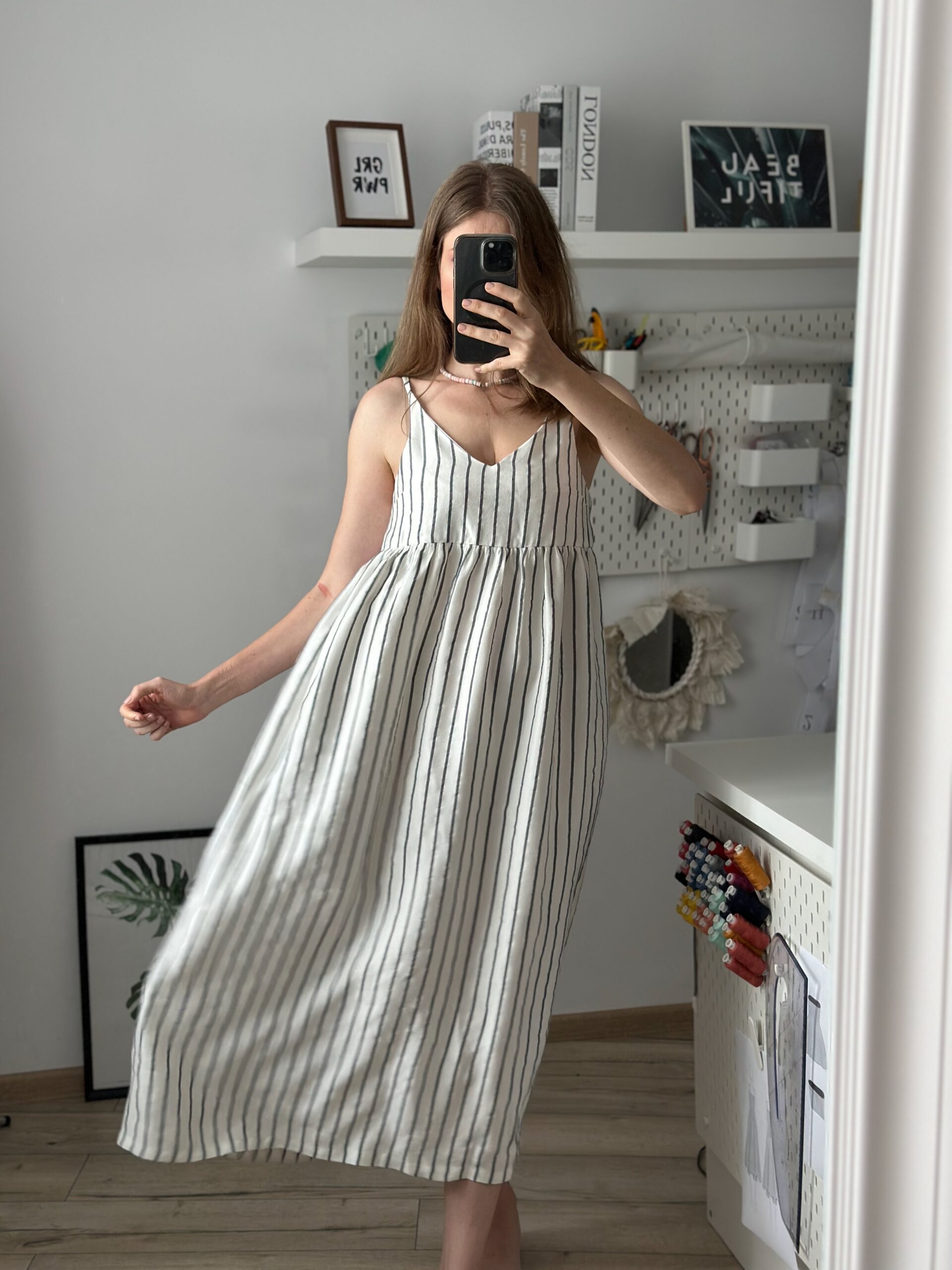 Woman wearing the sewn sundress pattern full length, striped cotton with gathered skirt in movement