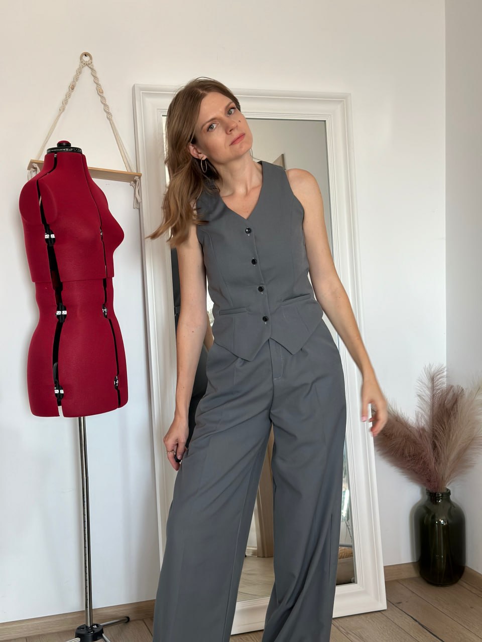 Grey tailored waistcoat worn buttoned with matching high-waisted wide-leg trousers — full body, straight-on view