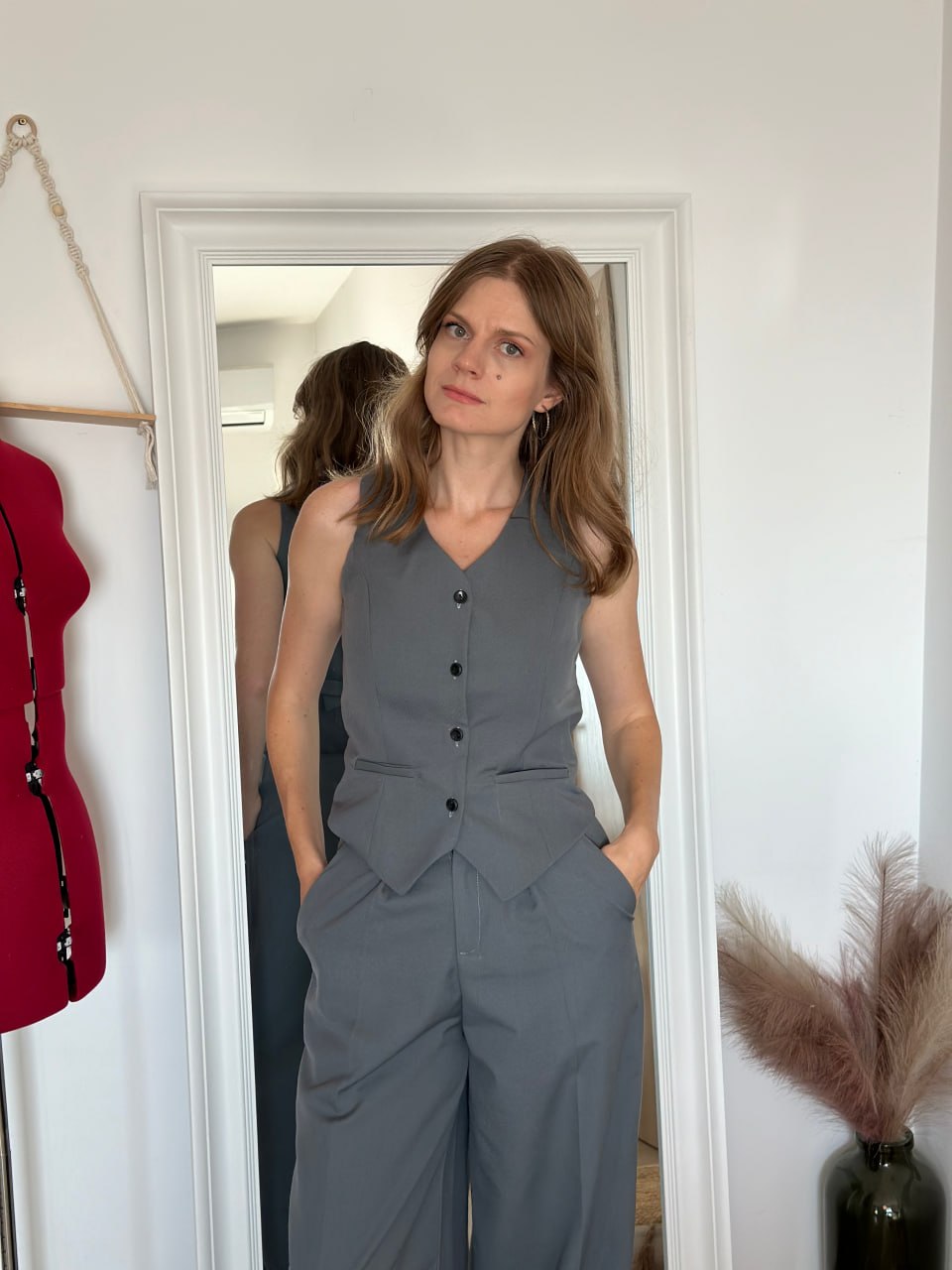 Tailored grey waistcoat buttoned over matching wide-leg trousers, full body front view
